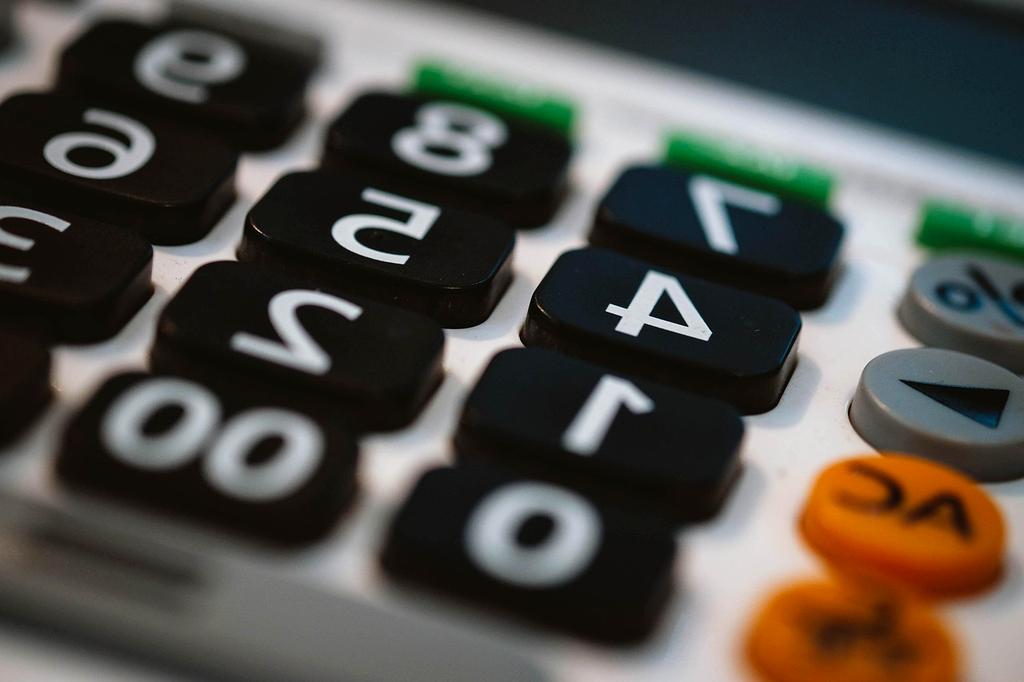 Calculator and papers representing debt reduction